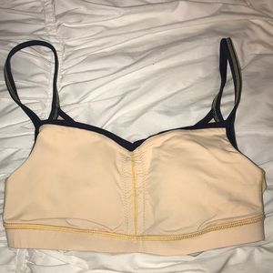 Yellow Lululemon sports bra with navy blue straps